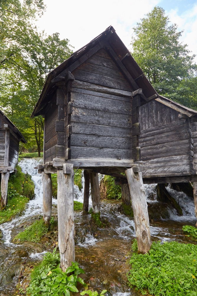 A group of wooden huts next to a hidden gem at Watermills Of Jajce Bosnia-Herzegovina 